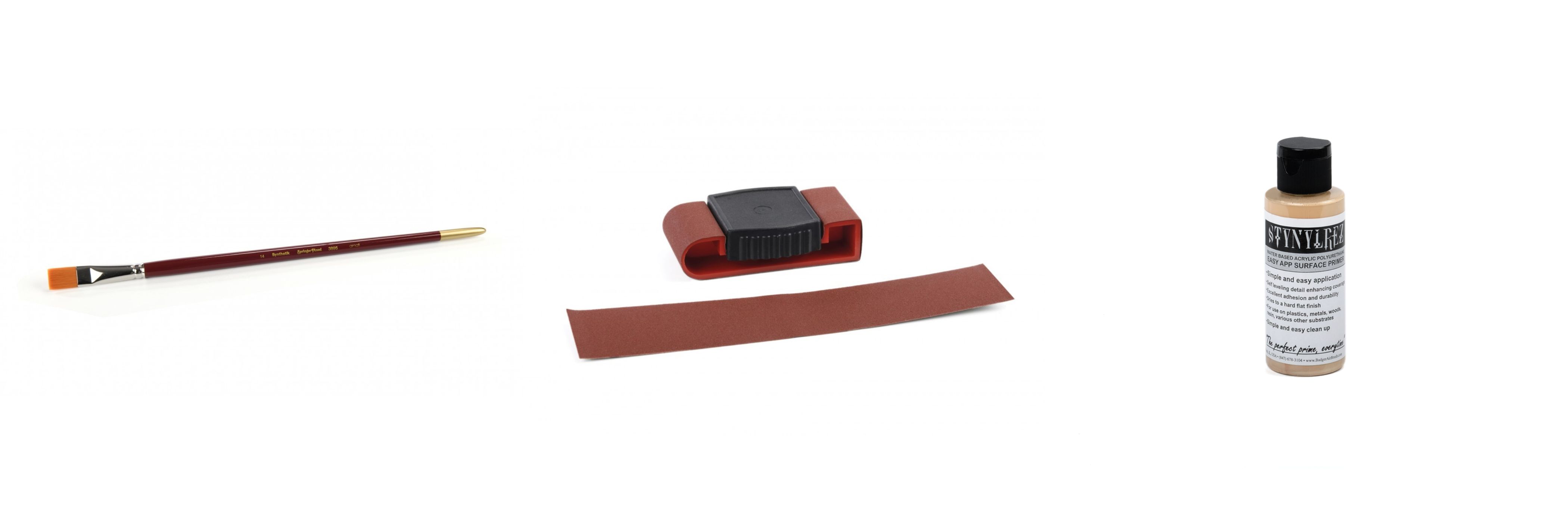 Flat synthetic brush, sanding block with abrasive strip, and bottle of acrylic surface primer for model ship building.