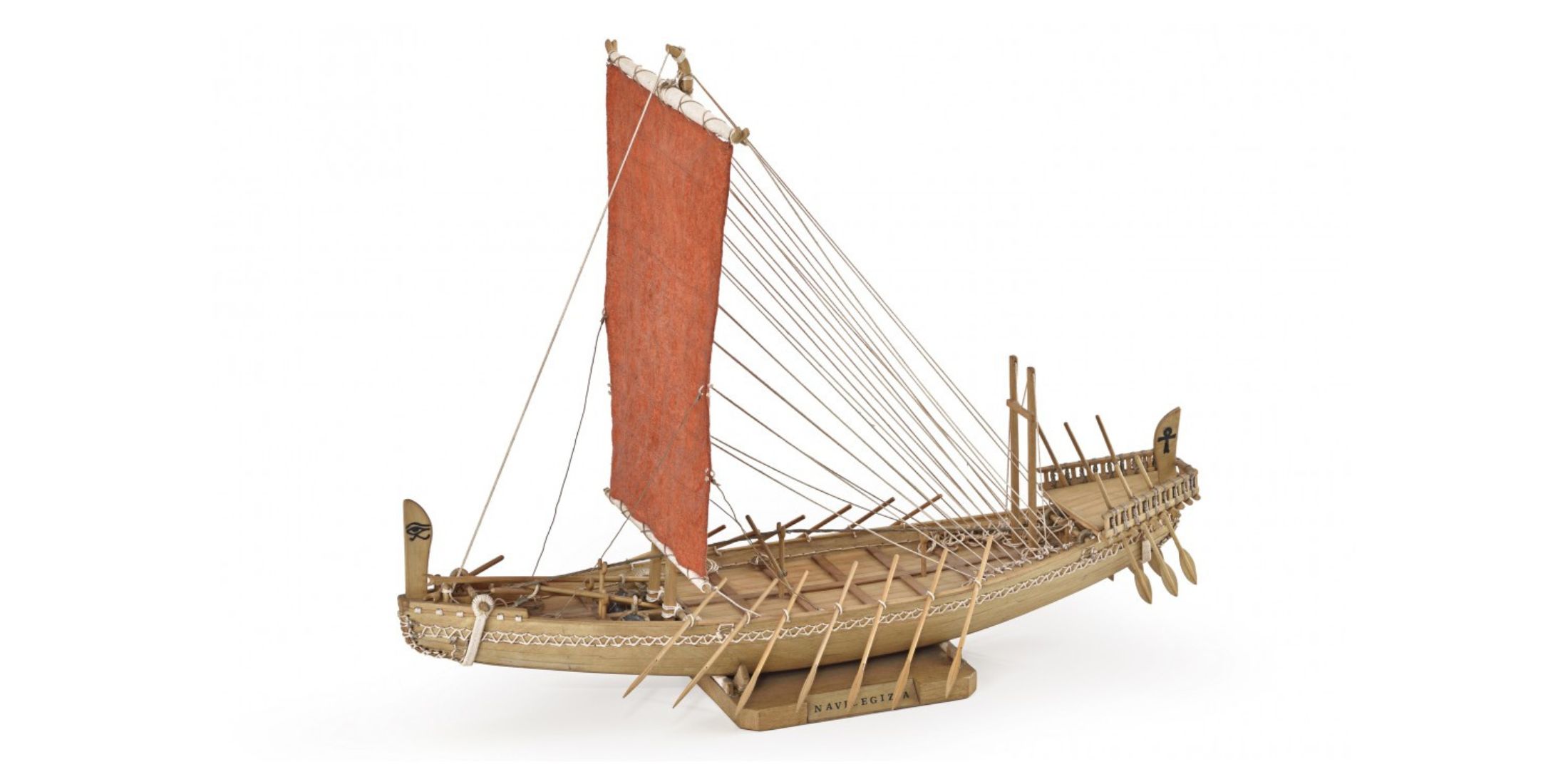Scale model of ancient Egyptian ship with red sail and oars