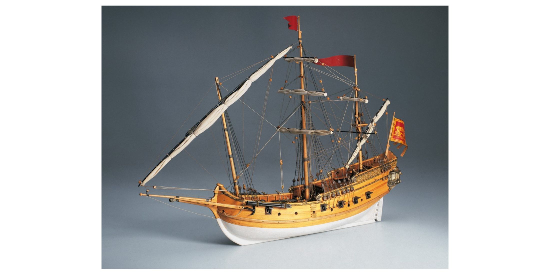 Wooden scale model of a Polish sailing ship, detailed with red flags and two-tone hull. Historical ship model kit for naval modeling.